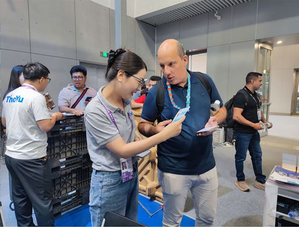 Our account manager and a buyer checking material details at the Canton Fair booth
