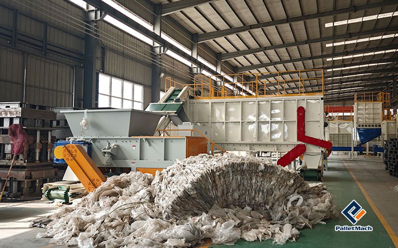 Waste plastic film before shredding, the bulky raw material feeding the plastic pallet line