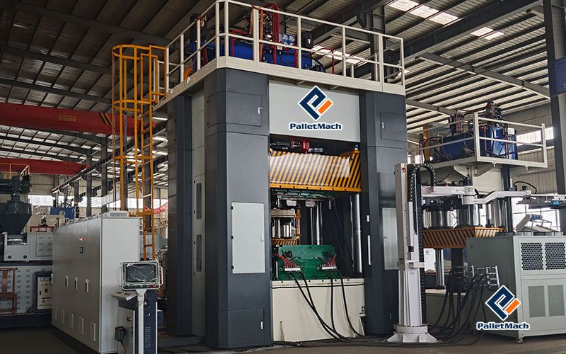 Front view of the custom plastic pallet production line installed at the PalletMach factory for testing